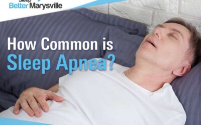 Man sleeping on his back with his mouth open, featured in Sleep Better Marysville's discussion on how common sleep apnea is.