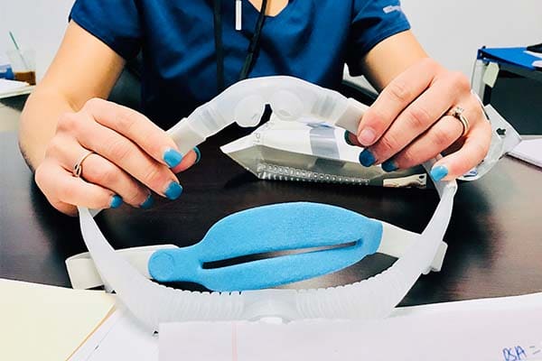 Sleep Better Columbus offers a great alternative in a simple device that is compact and lightweight. With Sleep Better Columbus, you'll get "peace of mind" knowing you're following the highest standards of care for your health. Image of young woman holding a CPAP device in her hands.