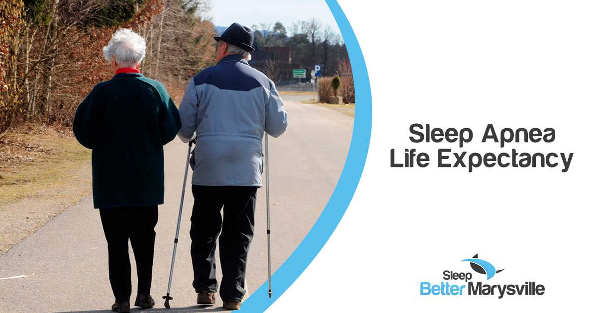 Older man using a pulse oximeter in bed to monitor blood oxygen levels that may be affected by sleep apnea