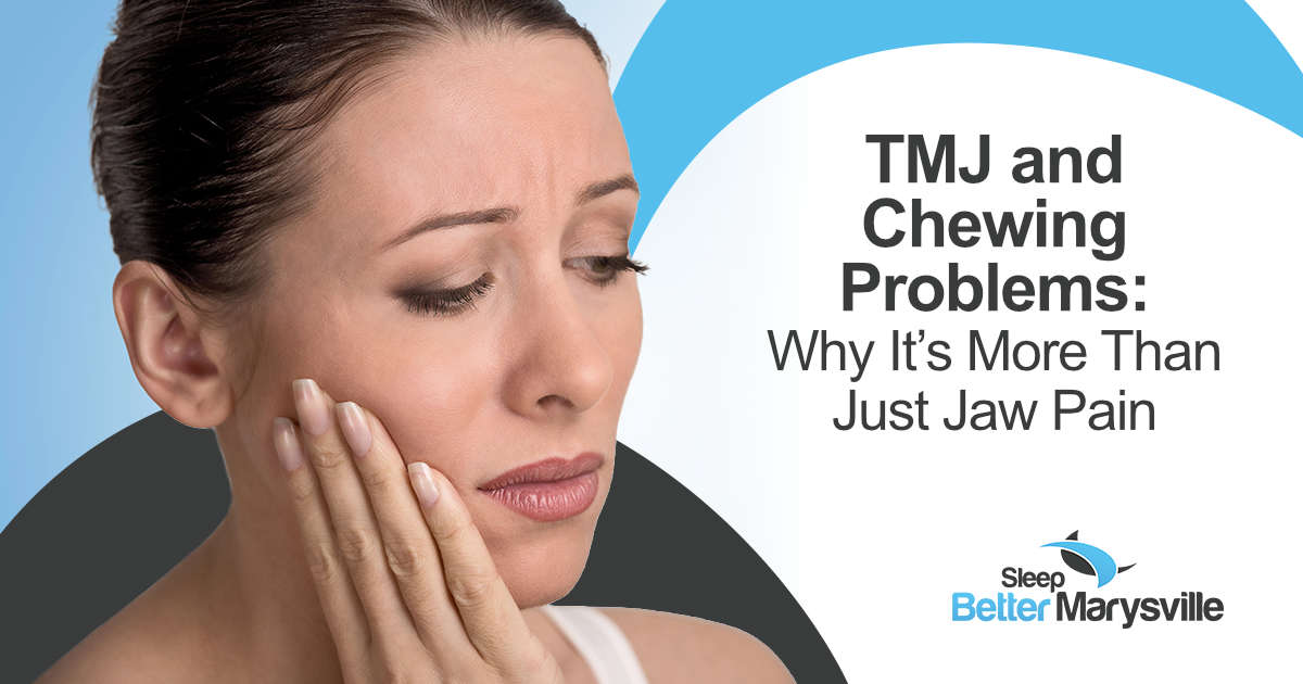 Woman holding her jaw while experiencing pain when chewing that may be related to TMJ
