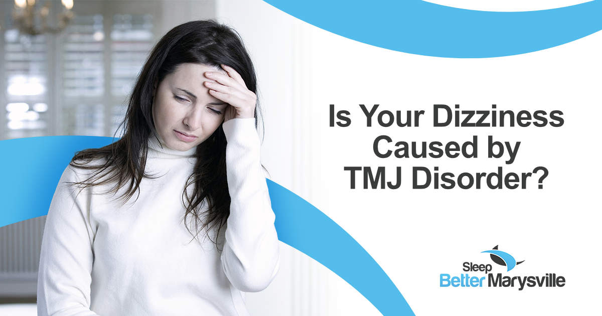 Woman holding her forehead while experiencing dizziness that may be related to TMJ disorder